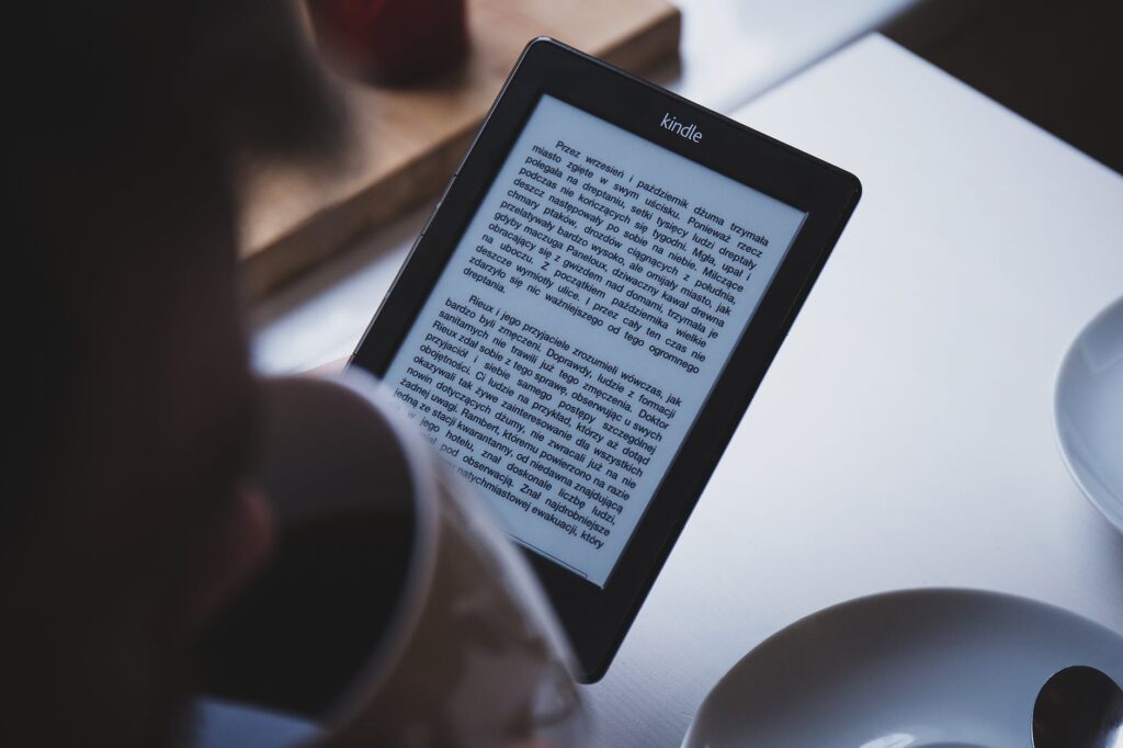 person using e book reader while drinking coffee 7 Steps to Creating an Affiliate Marketing Program for Small Businesses