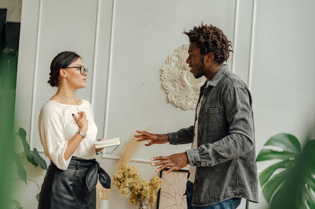 man in gray dress shirt holding woman in white dress business coach